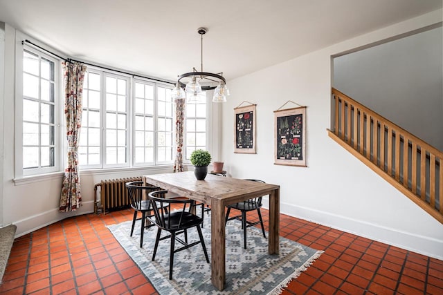 dining room with stairway, baseboards, an inviting chandelier, radiator heating unit, and tile patterned flooring