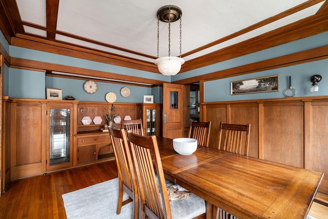 dining area featuring beverage cooler, wood finished floors, and crown molding