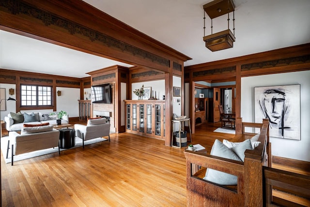 living room with light wood-type flooring and a fireplace