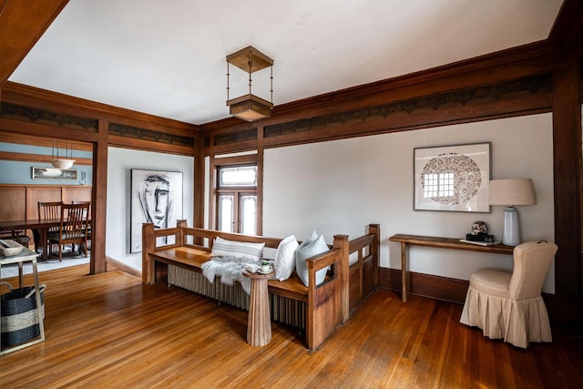 interior space featuring baseboards, hardwood / wood-style flooring, and ornamental molding