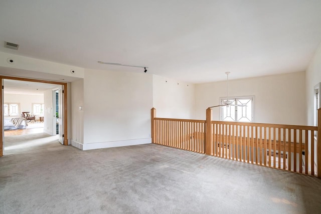 unfurnished room featuring carpet flooring and visible vents