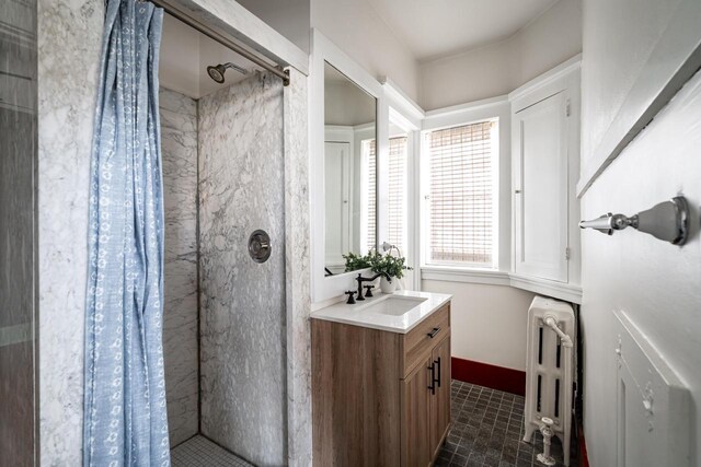 full bathroom featuring radiator, a stall shower, brick patterned floor, and vanity