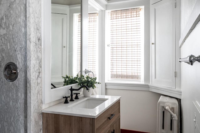 bathroom featuring radiator heating unit and vanity