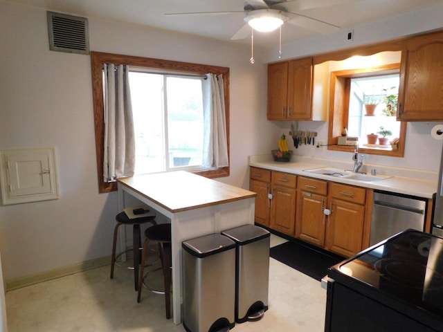 kitchen featuring light floors, dishwasher, a sink, black range with electric stovetop, and visible vents