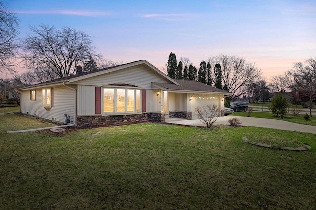 2500 S Brookside Pkwy, New Berlin, WI 53151 - ranch-style house with a front yard, driveway, stone siding, and a garage