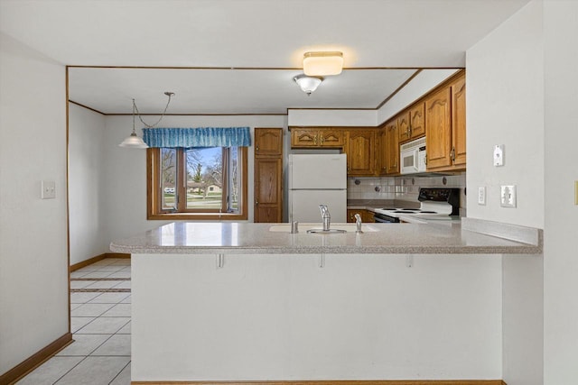 2500 S Brookside Pkwy, New Berlin, WI 53151 - kitchen featuring brown cabinets, a sink, baseboards, white appliances, and a peninsula