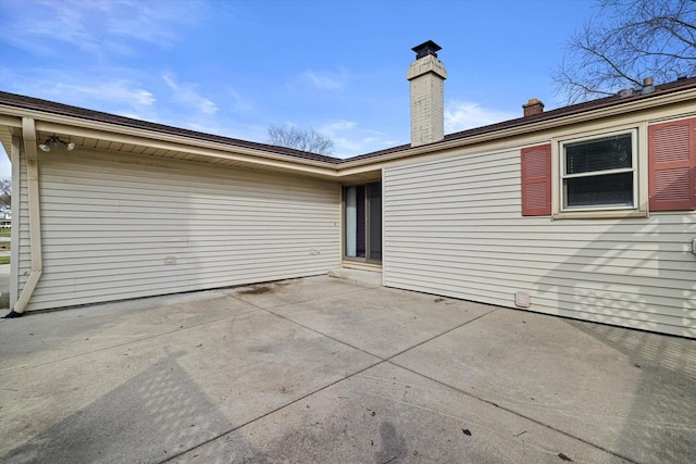 2500 S Brookside Pkwy, New Berlin, WI 53151 - rear view of house featuring a chimney and a patio