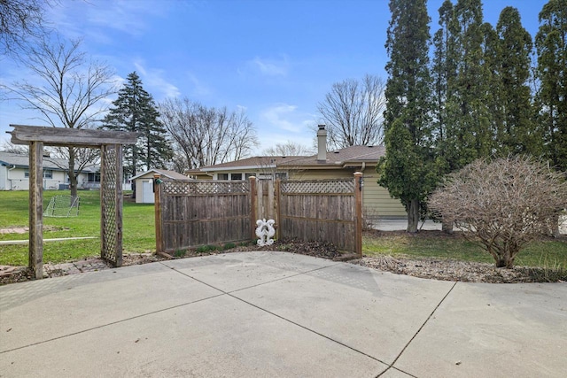 2500 S Brookside Pkwy, New Berlin, WI 53151 - view of property exterior with a patio, a shed, an outbuilding, fence, and a yard