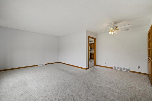 2500 S Brookside Pkwy, New Berlin, WI 53151 - carpeted spare room with visible vents, a ceiling fan, and baseboards