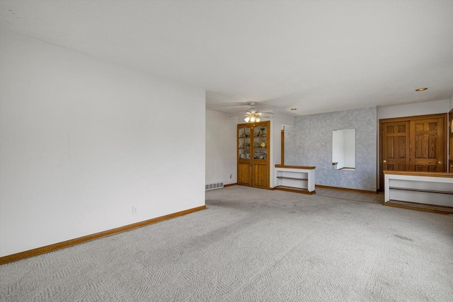 2500 S Brookside Pkwy, New Berlin, WI 53151 - unfurnished living room featuring visible vents, ceiling fan, carpet floors, and baseboards