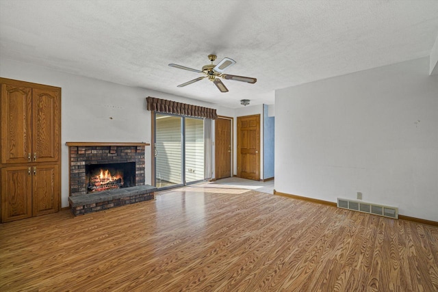 2500 S Brookside Pkwy, New Berlin, WI 53151 - unfurnished living room featuring a ceiling fan, visible vents, wood finished floors, and a textured ceiling