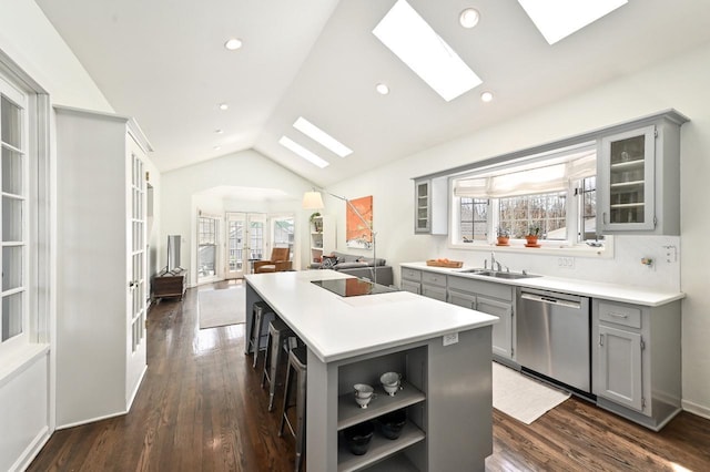 kitchen with a kitchen island, stainless steel dishwasher, open shelves, gray cabinetry, and a sink