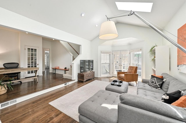 living room featuring a skylight, french doors, stairs, and wood finished floors