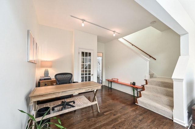 home office with baseboards, rail lighting, and wood finished floors