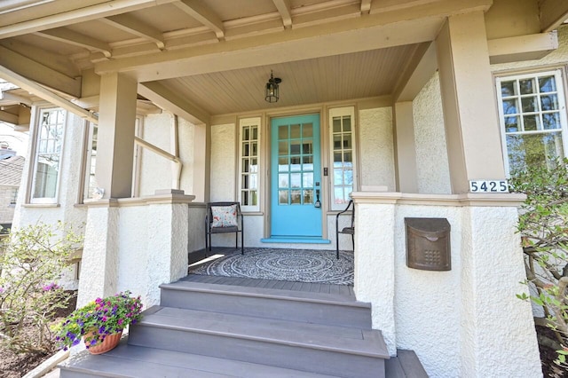 view of exterior entry featuring stucco siding