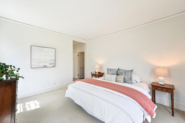 bedroom featuring baseboards and light colored carpet
