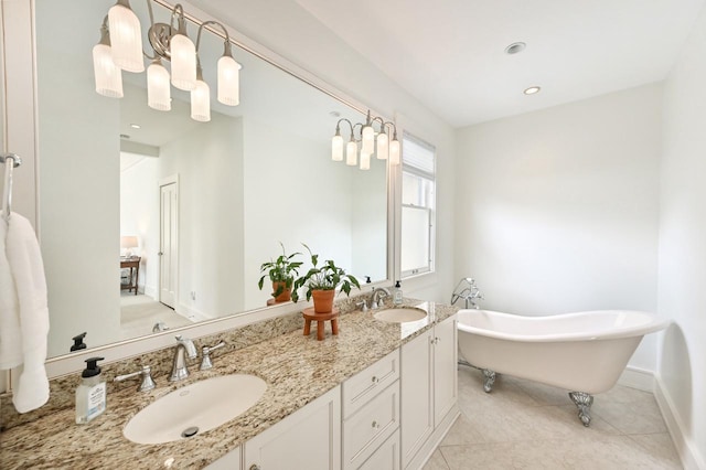 bathroom featuring double vanity, a sink, tile patterned floors, and a soaking tub