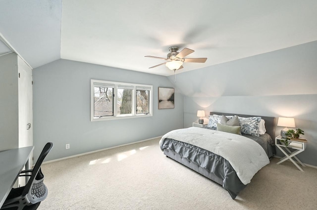 bedroom with carpet floors, ceiling fan, baseboards, and lofted ceiling
