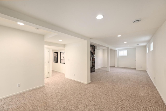 below grade area with light colored carpet, recessed lighting, and baseboards