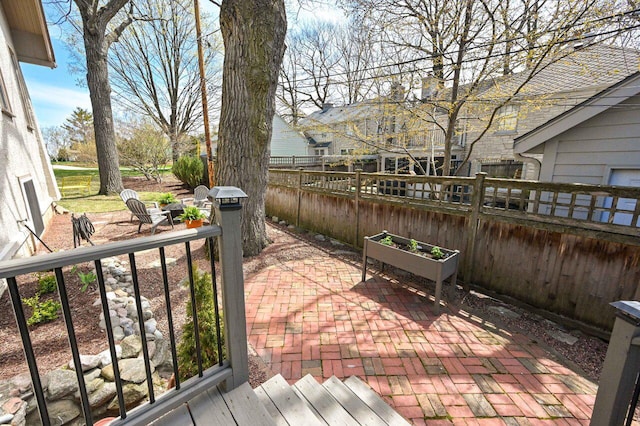view of patio / terrace featuring fence
