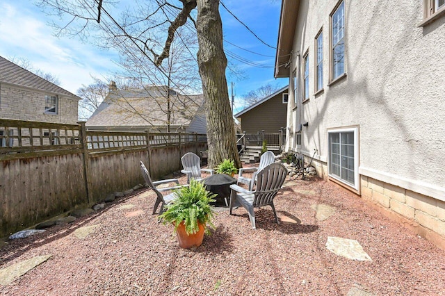 view of patio / terrace featuring fence and an outdoor fire pit