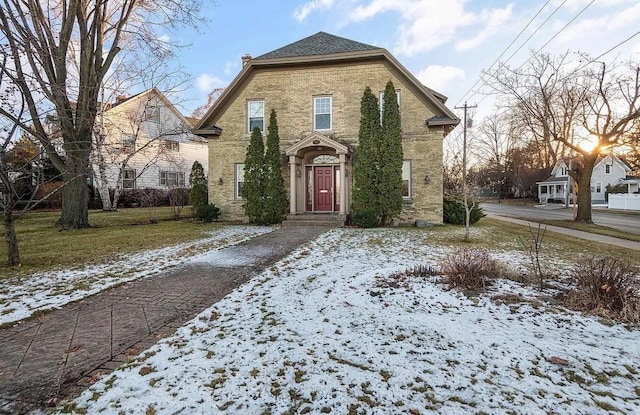 french provincial home with brick siding