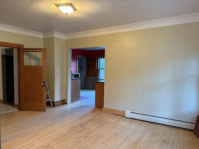 2776 S Superior St, Bay View, WI 53207 - spare room featuring a baseboard heating unit, crown molding, and light wood-style flooring