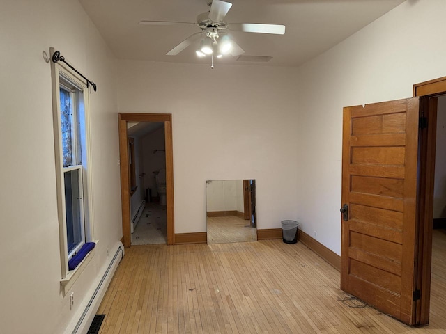 2776 S Superior St, Bay View, WI 53207 - empty room featuring a baseboard radiator, ceiling fan, light wood finished floors, and baseboard heating