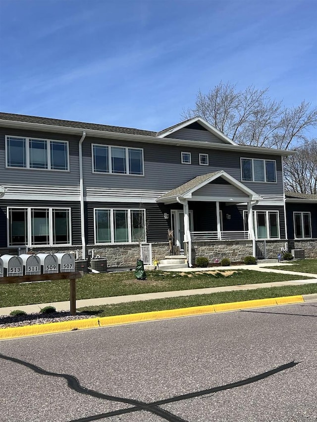 511 Madison St Unit 511, Sauk City, WI 53583 - view of front of house featuring stone siding, central AC, and covered porch