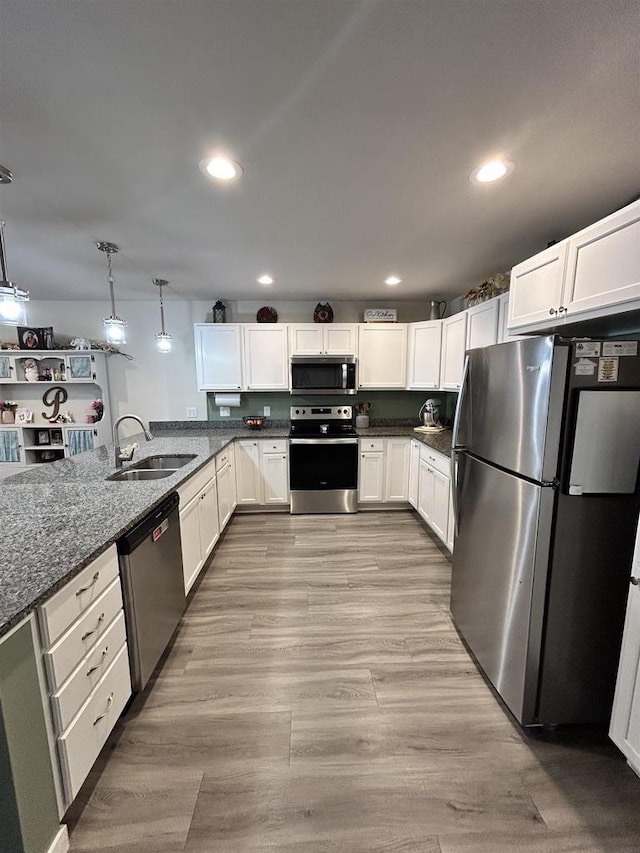 511 Madison St Unit 511, Sauk City, WI 53583 - kitchen with dark stone counters, recessed lighting, a sink, stainless steel appliances, and white cabinetry