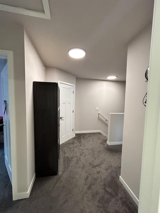 511 Madison St Unit 511, Sauk City, WI 53583 - interior space featuring baseboards, dark carpet, and an upstairs landing