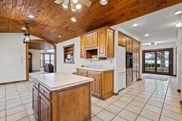 2108 Woodlawn Ln, Appleton, WI 54914 - kitchen featuring ceiling fan, light countertops, arched walkways, oven, and light tile patterned flooring