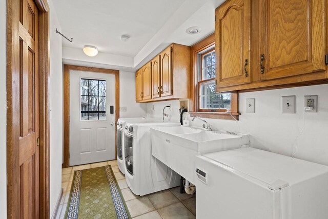 2108 Woodlawn Ln, Appleton, WI 54914 - clothes washing area featuring light tile patterned floors, washer and dryer, cabinet space, and a sink