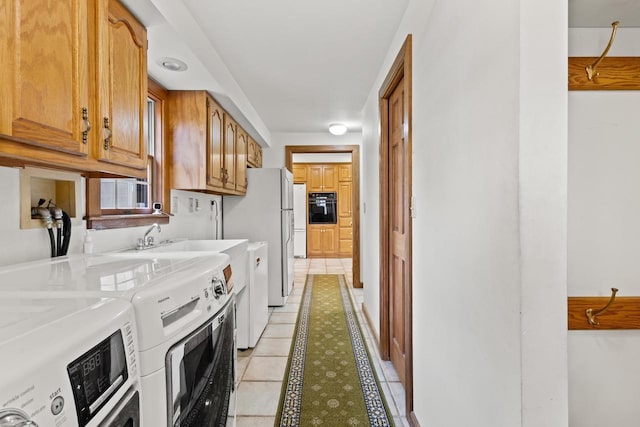2108 Woodlawn Ln, Appleton, WI 54914 - washroom with separate washer and dryer, light tile patterned flooring, laundry area, and a sink