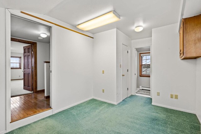 2108 Woodlawn Ln, Appleton, WI 54914 - carpeted spare room with baseboards and a baseboard radiator