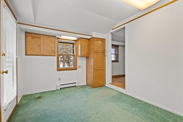 2108 Woodlawn Ln, Appleton, WI 54914 - spare room with baseboards, lofted ceiling, light colored carpet, and a baseboard radiator