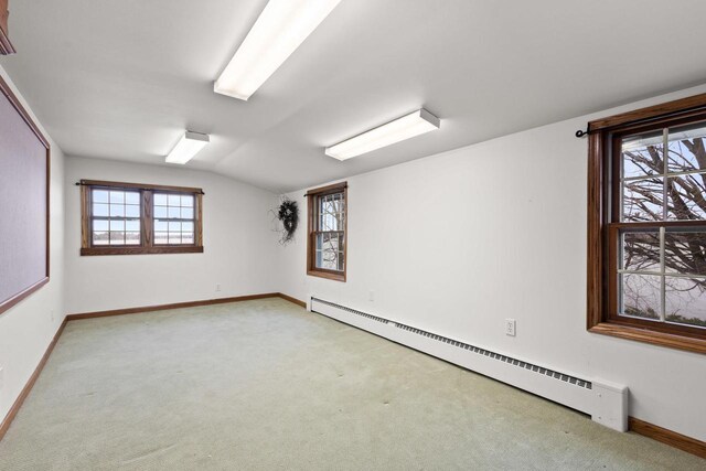 2108 Woodlawn Ln, Appleton, WI 54914 - empty room featuring baseboards, a baseboard heating unit, light colored carpet, and vaulted ceiling