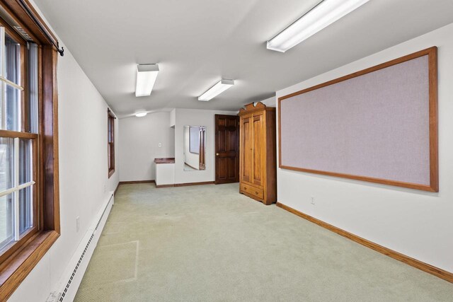 2108 Woodlawn Ln, Appleton, WI 54914 - empty room with baseboards, light carpet, lofted ceiling, and a baseboard heating unit