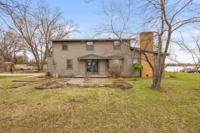 2108 Woodlawn Ln, Appleton, WI 54914 - rear view of house with a chimney and a yard