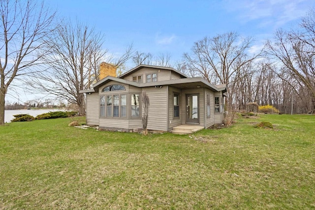 2108 Woodlawn Ln, Appleton, WI 54914 - exterior space featuring a lawn and a chimney