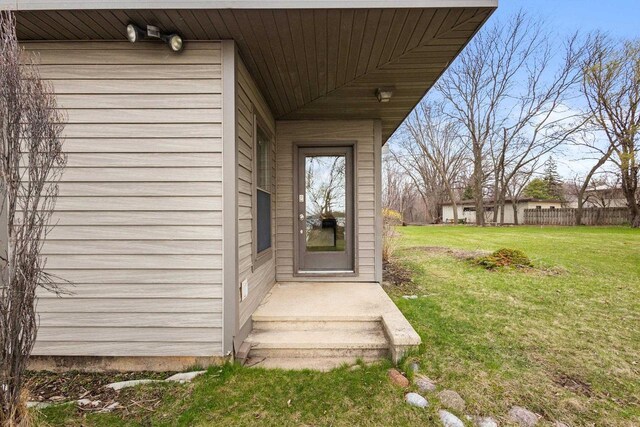 2108 Woodlawn Ln, Appleton, WI 54914 - view of exterior entry with a lawn and fence