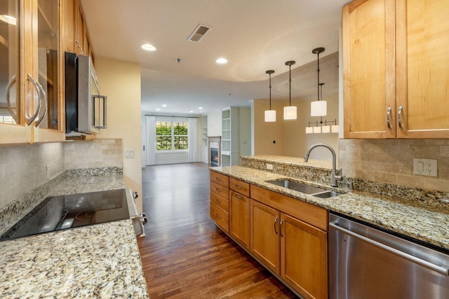 kitchen featuring visible vents, appliances with stainless steel finishes, a sink, light stone counters, and dark wood-type flooring