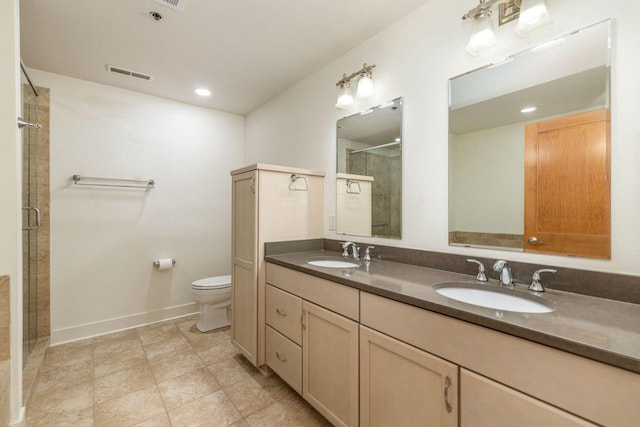 full bathroom featuring double vanity, visible vents, a shower stall, and a sink