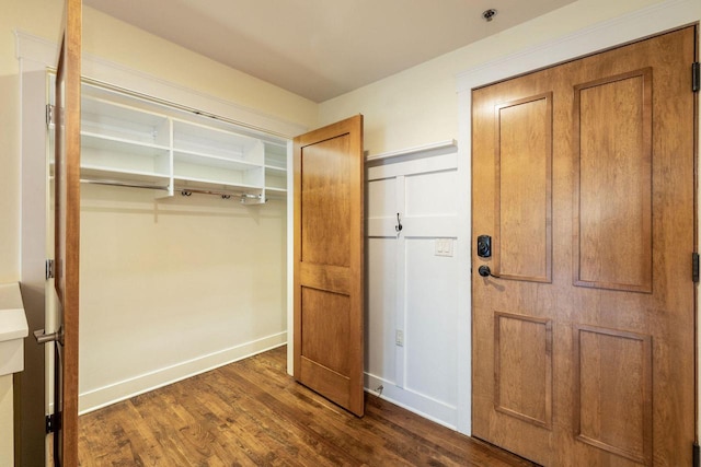 interior space with baseboards and dark wood-style floors