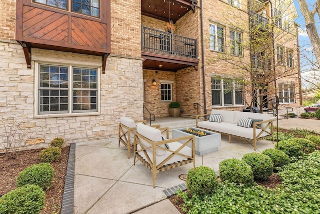 view of patio with an outdoor living space and a balcony