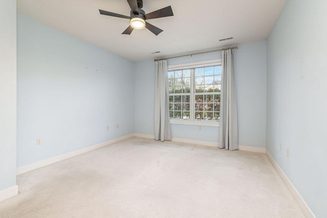 unfurnished room with carpet floors, baseboards, a ceiling fan, and visible vents