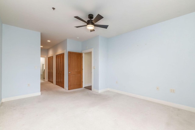unfurnished room with a ceiling fan, baseboards, recessed lighting, and light carpet