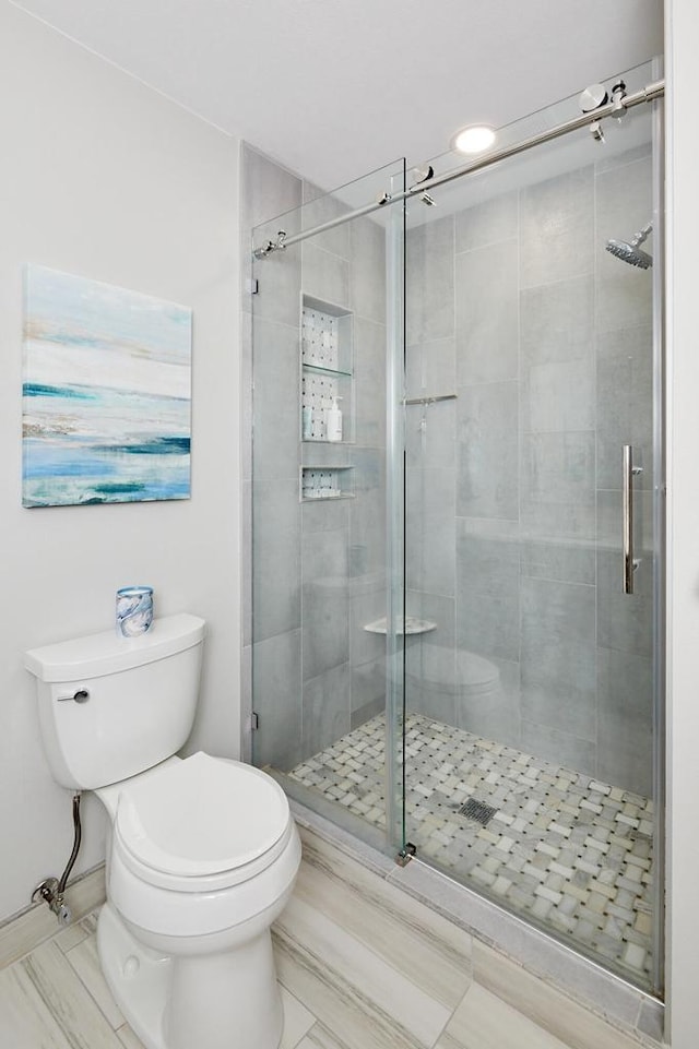 bathroom with toilet, a stall shower, tile patterned flooring, and recessed lighting