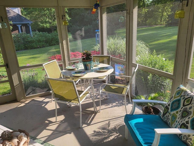 sunroom / solarium with outdoor dining area and plenty of natural light