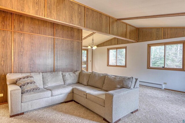 10749 N Namekagon Ln, Hayward, WI 54843 - living area featuring baseboard heating, baseboards, an inviting chandelier, vaulted ceiling, and carpet